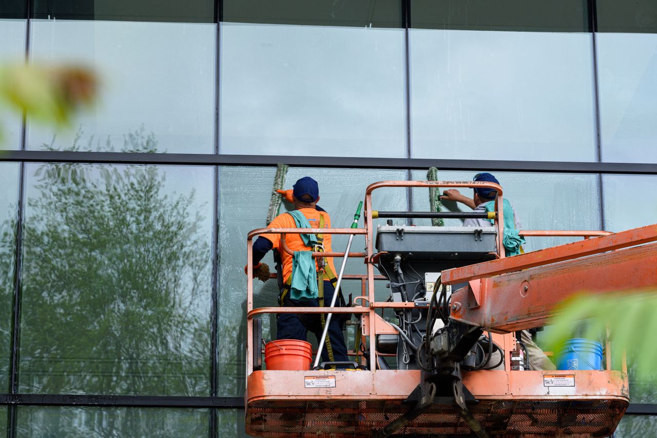 Professional Window Cleaners At Work On Glass Building 31983866